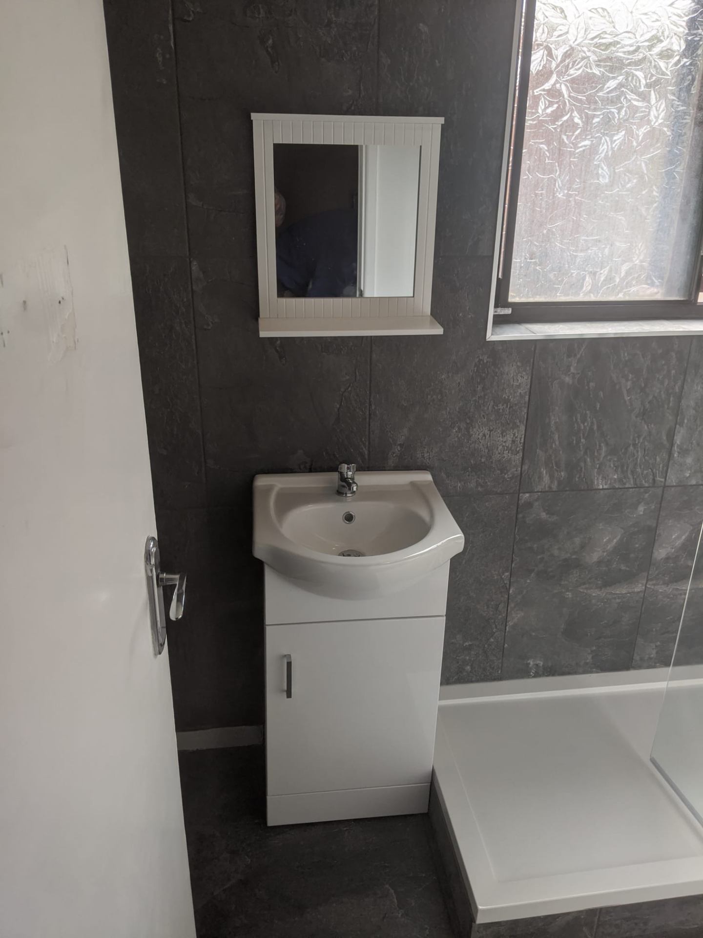 New vanity unit with slate-effect splashback and modern basin